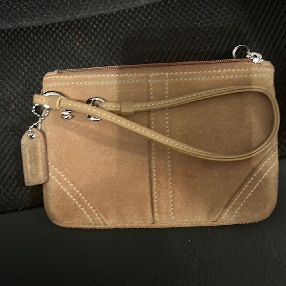 Tan Coach Wristlet, one tiny mark on front.